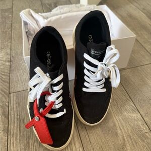 Black and White Sneakers with Red Tag